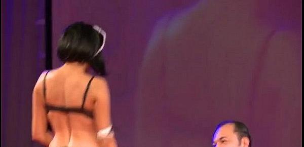  Sexy brunette getting wet on the stage